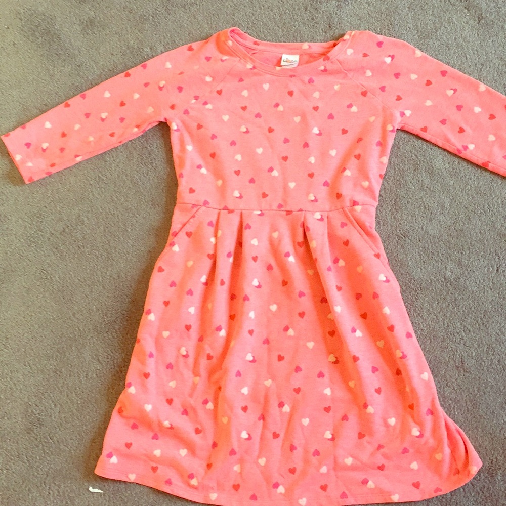 A pink dress with red pink and white hearts on it